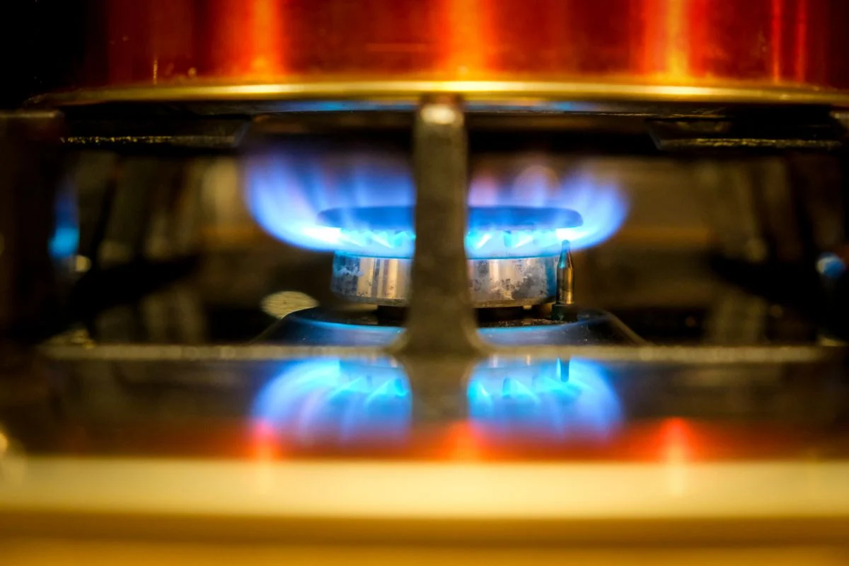 Blue flame at a residential gas cooktop burner