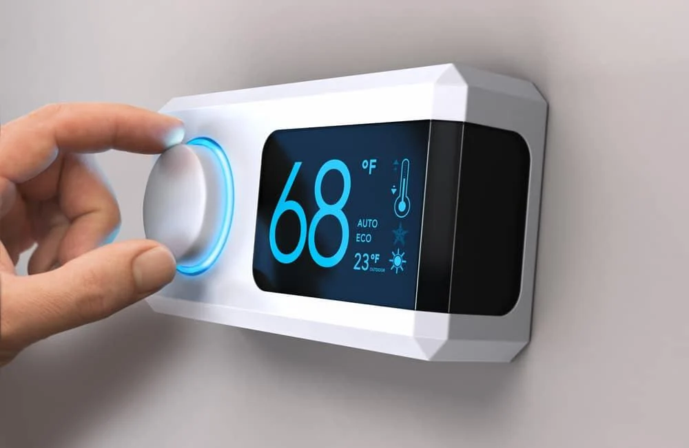 Home heating thermostat with illuminated temperature display
